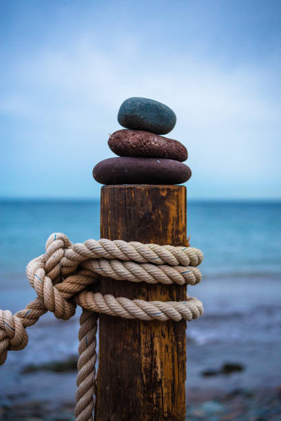 pyramid of stones on posted with rope