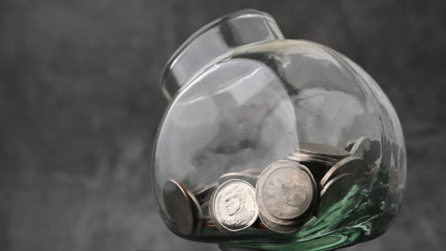 Thai baht money coins in glass bottles money saving saving video rotation 4k