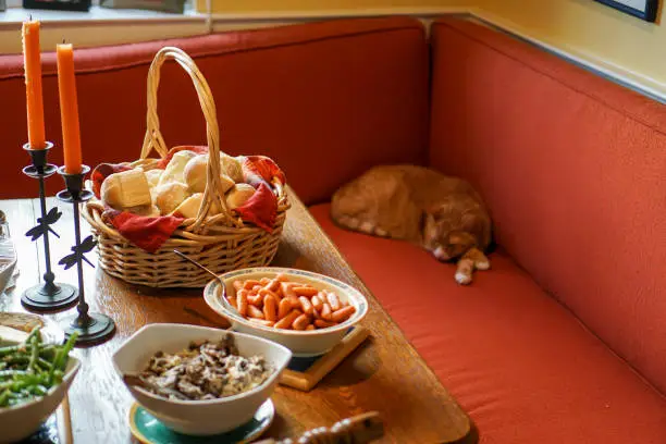 Photo of Dinner table with cat sleeping nearby