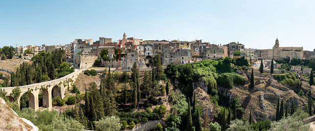 Gravina, Italy - August 31 2020: Panorama of Gravina in Puglia ancient town, bridge and canyon.Puglia Italy.