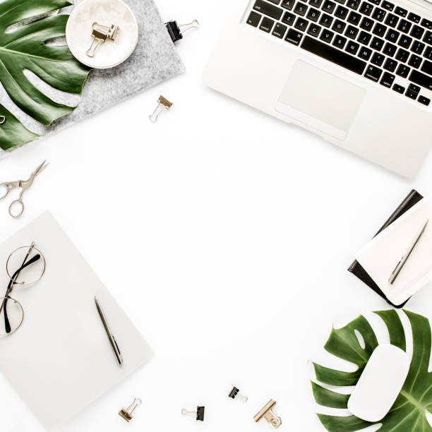 istock Home office workspace mockup with laptop, tropical leaves Monstera, clipboard, notebook and accessories on white background. Flat lay, top view 1277186843