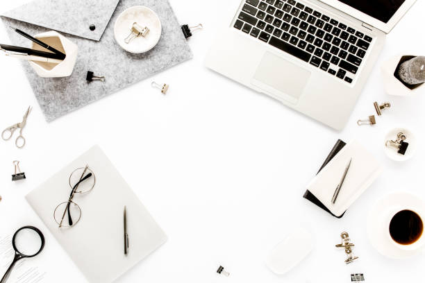 istock Home office workspace frame with laptop, clipboard, notebook and accessories on white background. Flat lay, top view 1277187597