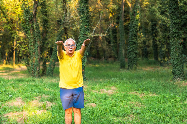 istock Senior runner with armband doing stretching. Autumn nature. 1277187820