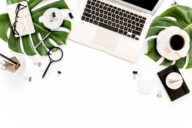 istock Home office workspace mockup with laptop, tropical leaves Monstera, clipboard, notebook and accessories on white background. Flat lay, top view 1277187867