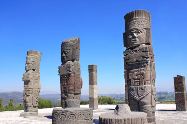Toltec Atlantes - columns on top Pyramid of Quetzalcoatl, Tula de Allende, Hidalgo state, Mexico. UNESCO world heritage site. On blue sky background