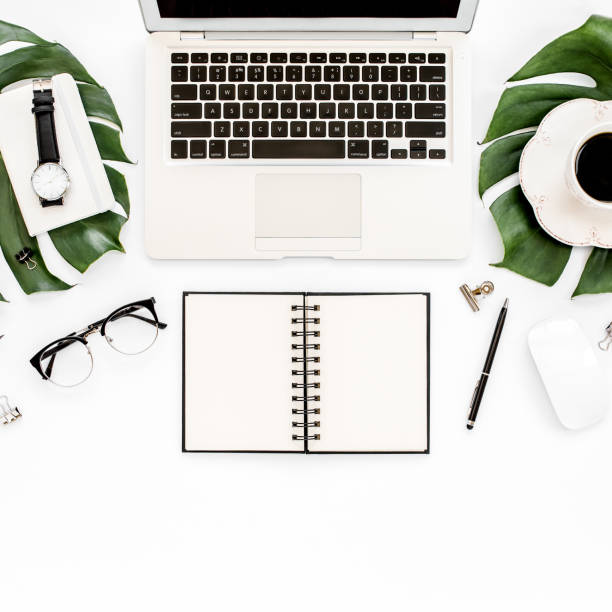 istock Home office workspace mockup with laptop, tropical leaves Monstera, clipboard, notebook and accessories on white background. Flat lay, top view 1277190192