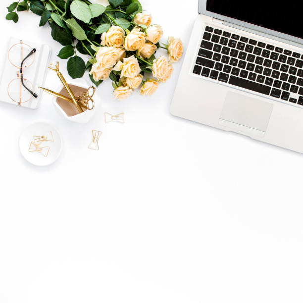 istock Female workspace with laptop, roses flowers, golden accessories, diary, computer, glasses on white background. Flat lay women's office desk. Top view 1277190322