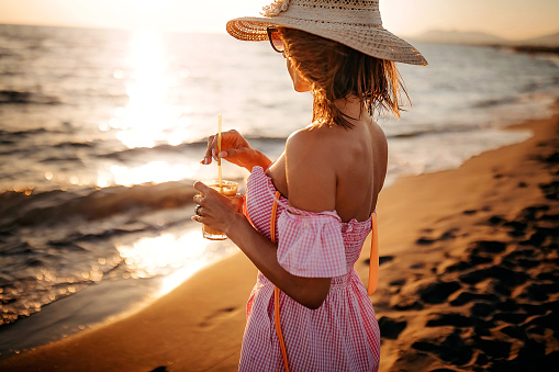 Young women enjoying summer near sea with coffee