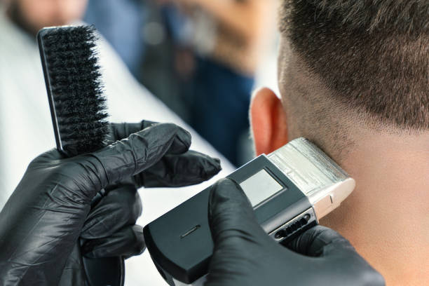 istock Barbershop client. Man getting his beard trimmed with electric razor 1277193270