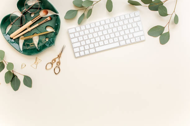 istock Flat lay home office desk. Female workspace with computer, plate sheet monstera, golden accessories, eucalyptus leaves, on beige background. Top view 1277194944