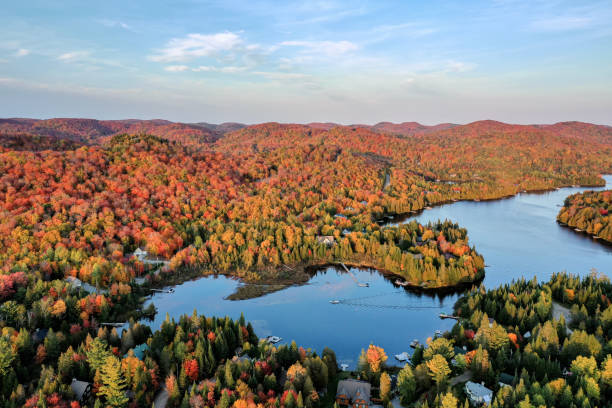 Aerial View of Laurentian's Landscape in Autumn at Sunset, Quebec, Canada Aerial View of Laurentian's Landscape in Autumn at Sunset. Village of St-Adolphe d’Howard and Lac Saint-Joseph, Quebec, Canada quebec stock pictures, royalty-free photos & images