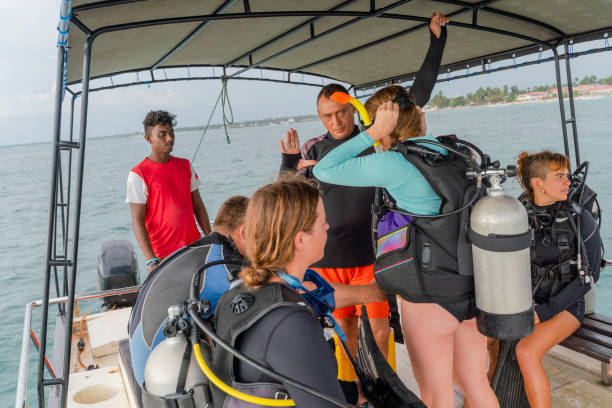 the big group of divers makes the final preparations aboard a boat, talking, and waiting for diving. - men latin american and hispanic ethnicity southern european descent mature adult imagens e fotografias de stock