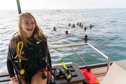 Divers have fun on a boat in the sea