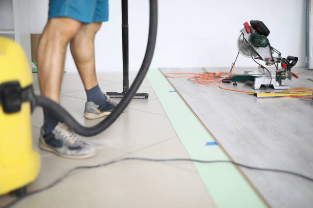 Empty room and design change Close-up of male worker cleaning floor with vacuum cleaner. Electrical drill equipment on laminate. Cleaning service. Renovation and construction site concept wood laminate flooring photos stock pictures, royalty-free photos & images