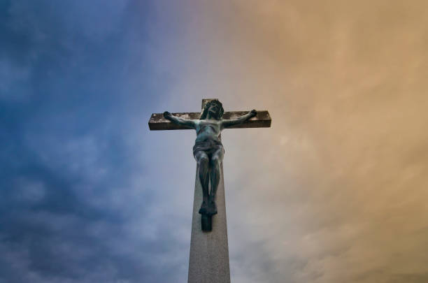 istock Jesus Christ on the cross against dramatic cloudy sky 1277196581