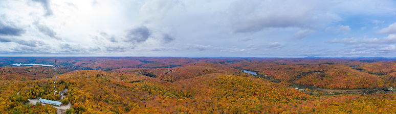 Aerial Panoramic View of Laurentian's Landscape and Communication Tower in Autumn at Sunset. Village of St-Adolphe d’Howard and Lac Saint-Joseph, Quebec, Canada