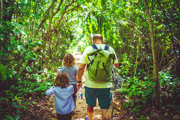 Father and two daughters hike in Costa Rica