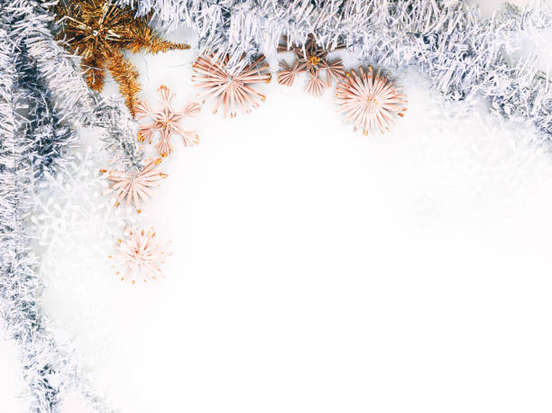 istock Beautiful Christmas background and lots of empty space for lettering and design. Shiny silver Christmas tinsel and artificial stars and snowflakes, Christmas toys. 1277200036