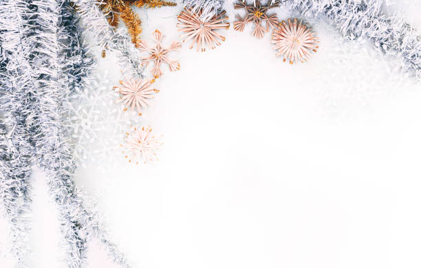 istock Beautiful Christmas background and lots of empty space for lettering and design. Shiny silver Christmas tinsel and artificial stars and snowflakes, Christmas toys. 1277200037