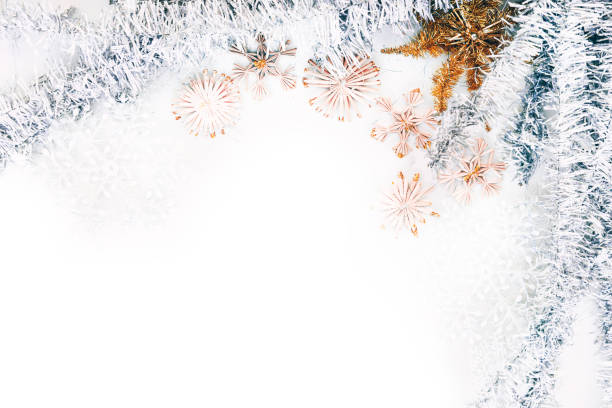 istock Beautiful Christmas background and lots of empty space for lettering and design. Shiny silver Christmas tinsel and artificial stars and snowflakes, Christmas toys. 1277200058