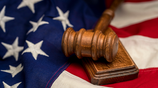 Photography of United States flag with a gavel and block.