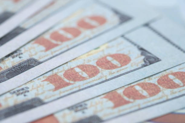 istock Close up of 100 dollar cash on table 1277201813