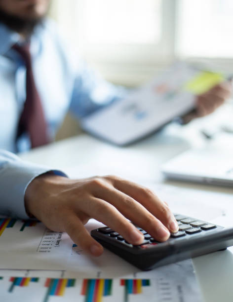 istock Business accounting concept, Business man using calculator with computer laptop, budget and loan paper in office. 1277202922