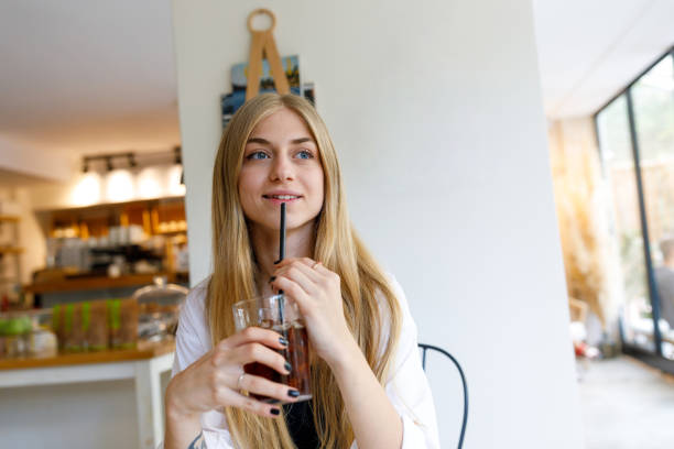istock Young blonde woman drinking cold brew 1277203384