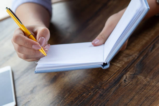 istock woman hand notepad in cafe 1277205815