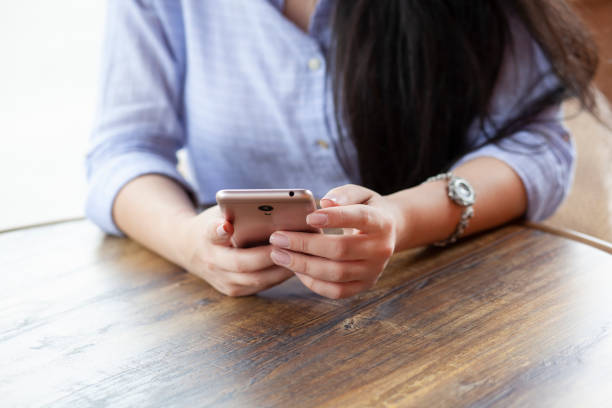 istock woman hand phone and coffee 1277205818