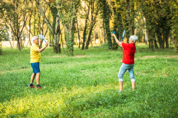 istock Happy active Senior woman playing badminton with her husband 1277209087