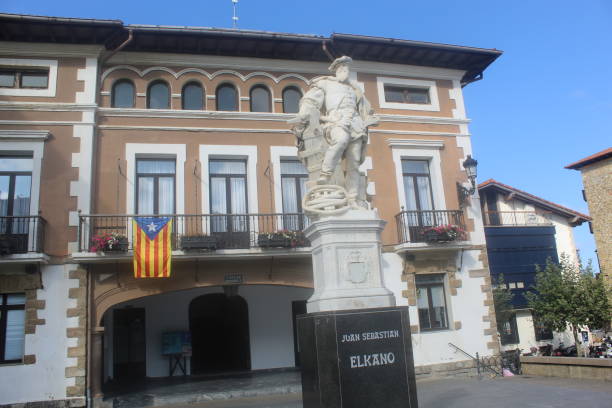 Getaria, Spain – September 11, 2020: Juan Sebastian Elcano statue and Getaria Town Hall. It’s visible an independentist catalan flag, since 11 September is the Catalan National Day.