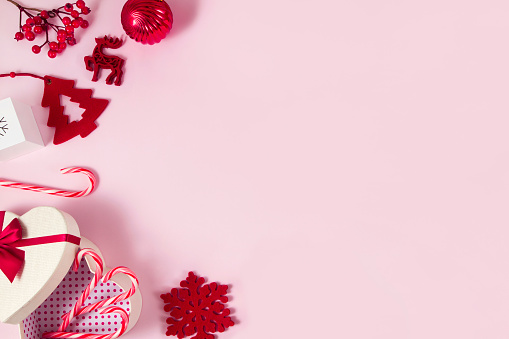 Christmas ornaments and gifts on pink background