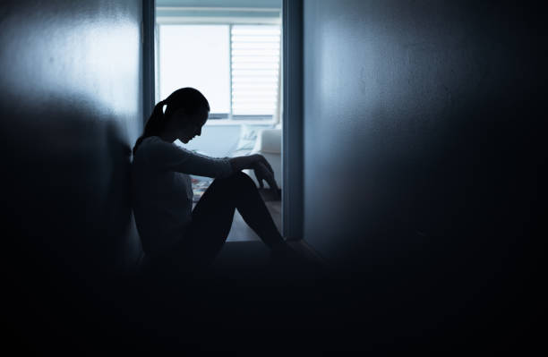 istock Young woman sitting alone on floor at home feeling sad looking down. 1277214341