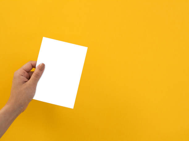istock hand is holding a white blank paper 1277214434
