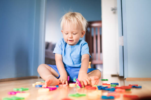 istock Boy playing with toys at home 1277215067