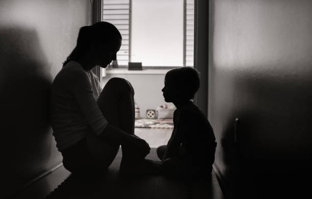istock Mother and son sitting on the floor at home. 1277215689