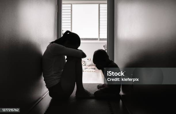 Sad Mother And Child Sitting On The Floor At Home Stock Photo - Download Image Now - Child, Violence, Women