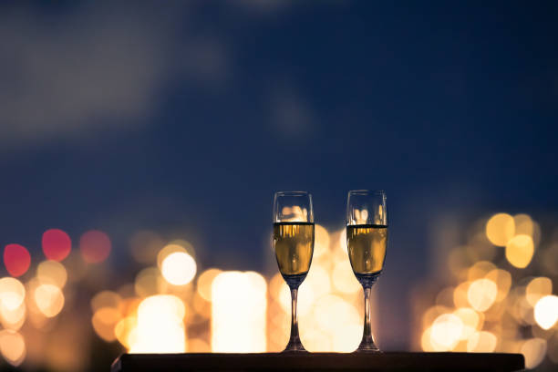 istock Pair of champagne drinks in a romantic candle light setting. 1277215769