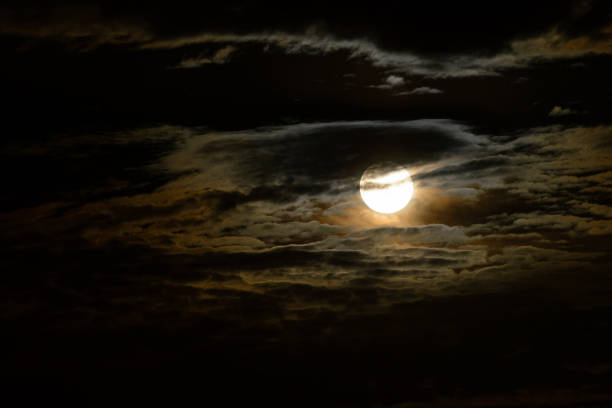 istock Bright super moon with orange and blue clouds and atmospheric fog around. 1277218051