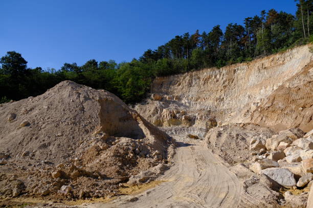 sandstone quarry in the middle of the woods stock photo