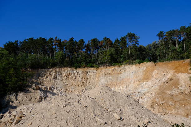 sandstone quarry in the middle of the woods stock photo