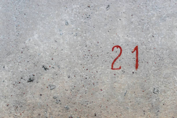 istock The number twenty one is written in red paint on an old cement wall. 1277220549