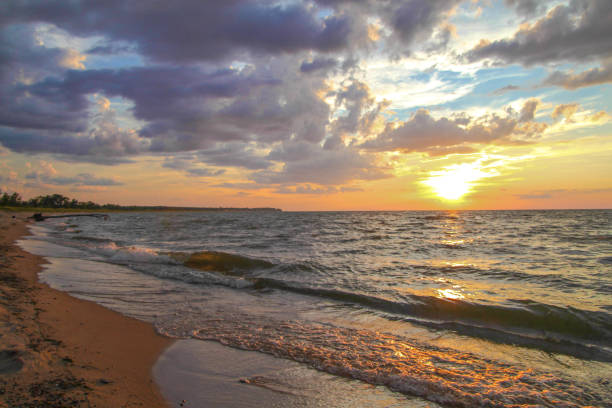 Dusk falls on a sandy beach along the coast of Lake Huron in the thumb of Michigan.