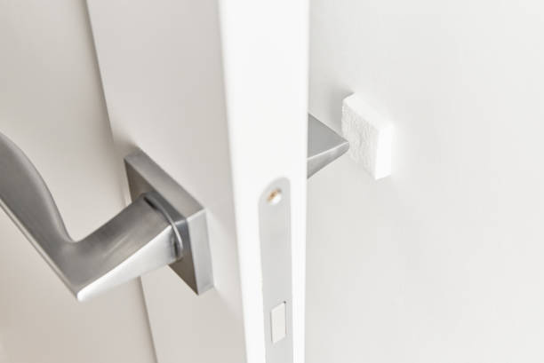 istock Silver door handle on a white door.  Furniture accesories, interior element 1277220898