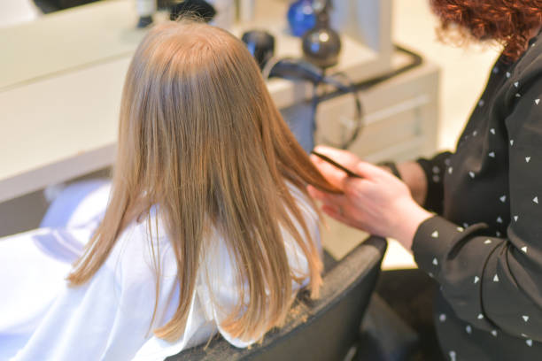 istock Mother cuts daughter at home during quarantine 1277221078