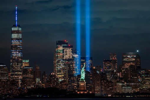 New Jersey - September 11, 2020, The Tribute in Light 9/11 memorial with the Statue of Liberty. New York City, USA