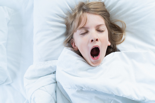 Little snoring girl, sleeping on pillow in bed with closed eyes. Evening late going to bed. Early morning wake up,rise to kindergarten,school.Bedtime,sweet dreams.Kids correct daily routine for child.
