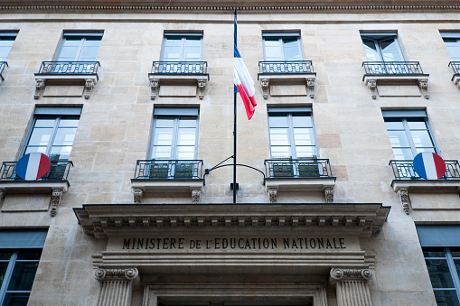 Paris : Education ministry facade, with french flag. It's a State building of french administration, where the education minister work, with all his team, senior official and official or public servant. Situated rue de Grenelle in Paris, 7 th district – arrondissement – in France.