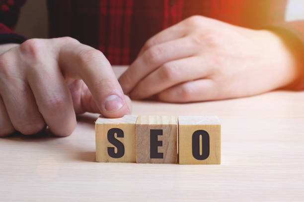 istock Hand arrange wood letters as SEO abbreviation Search Engine Optimization 1277226473